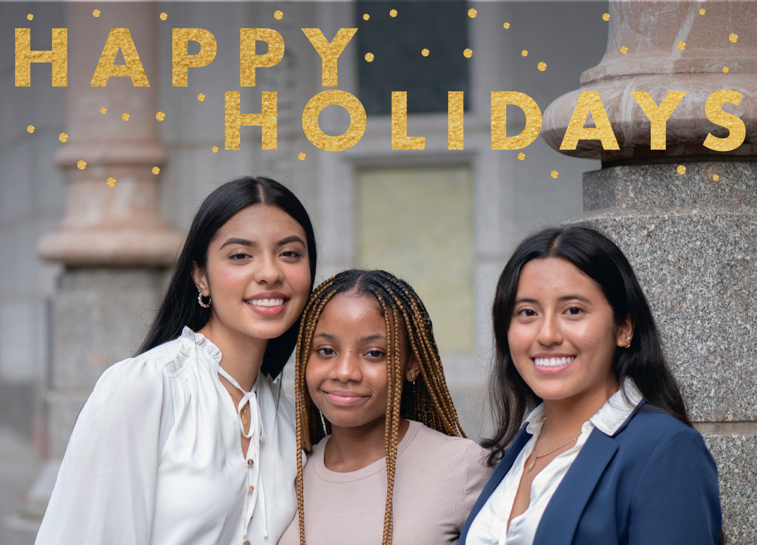 Happy Holidays text over a photo of three young women