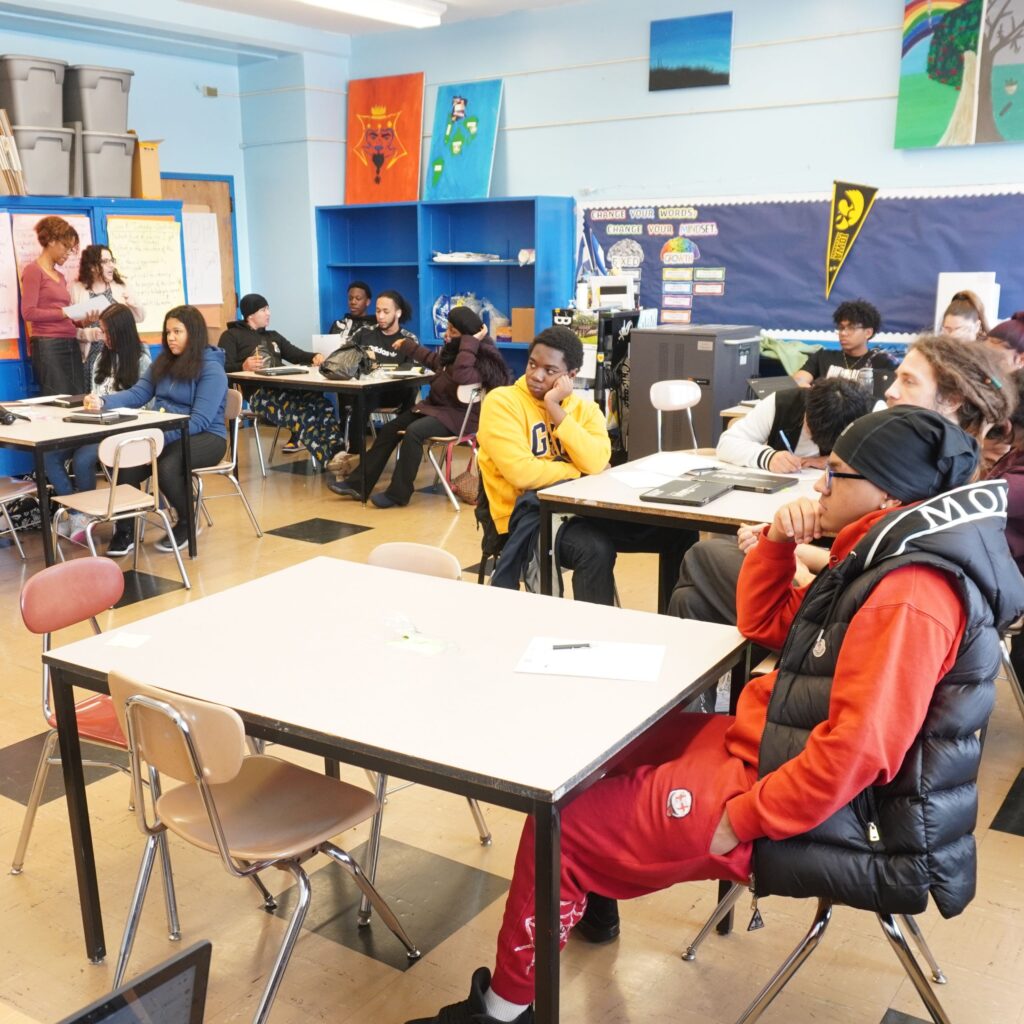 Students sit at desks in a classroom