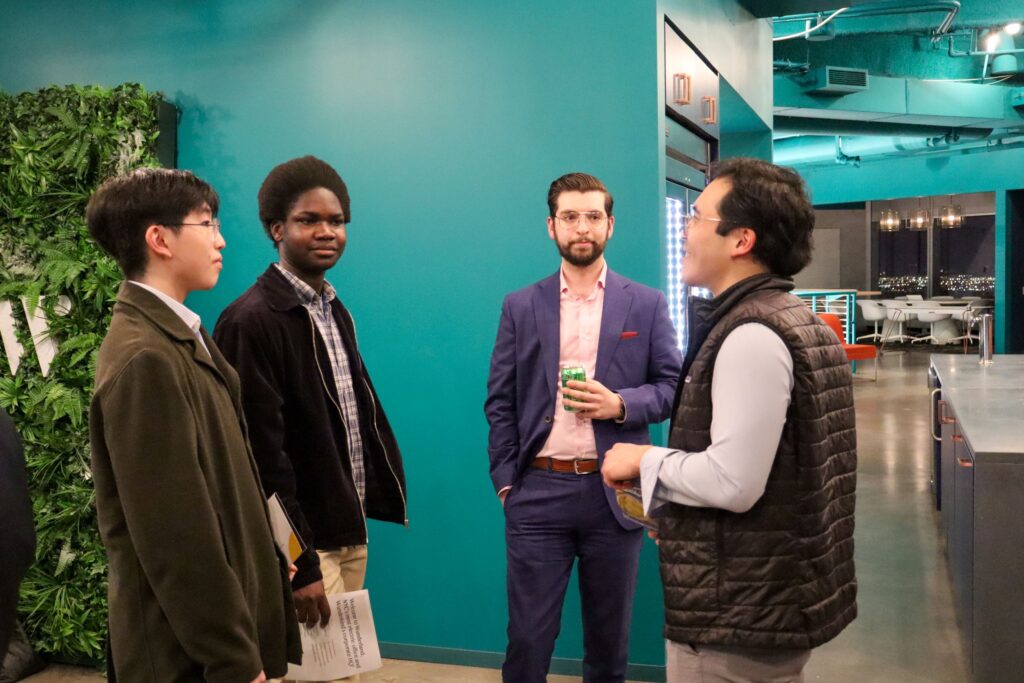 Junior Board members talk to alumni during a field trip at Wunderkind