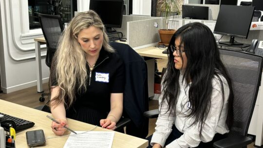 A Junior Board member helps an alum with their resume