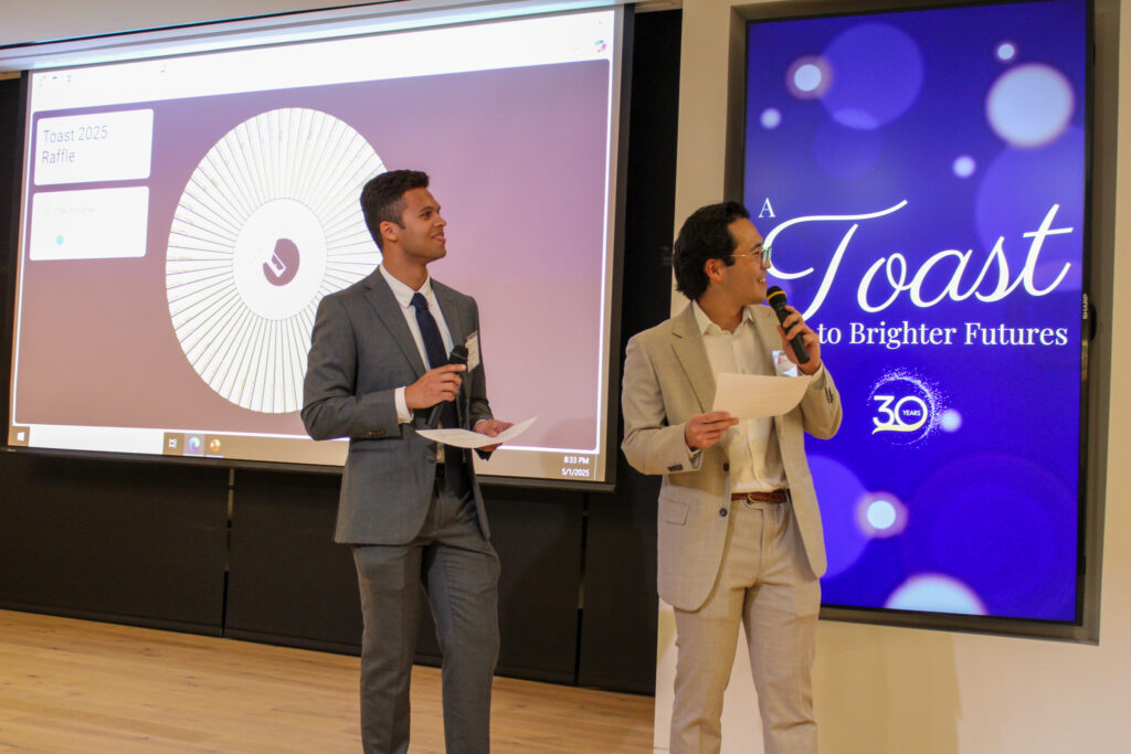 Two Junior Board members present the raffle at Toast