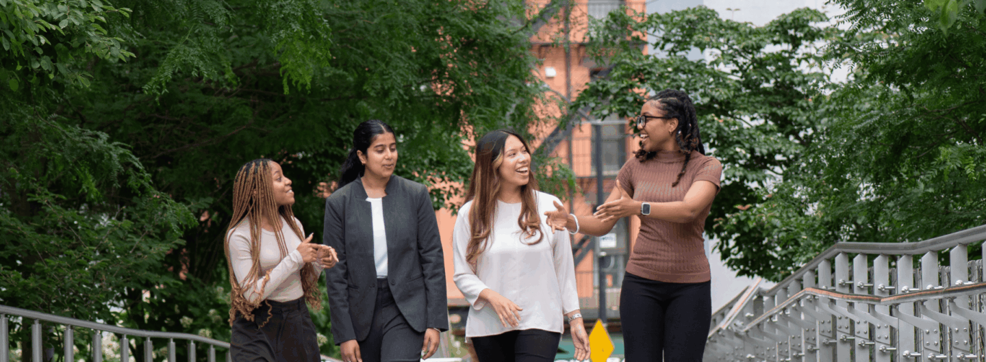 Four students walk in a row